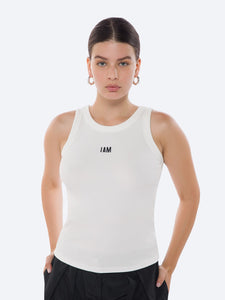 Front view of the I AM ME TANK WOMEN WHITE  by IAM ACTIVESTUDIOS, showcasing its sleek design and embroidery logo detail.